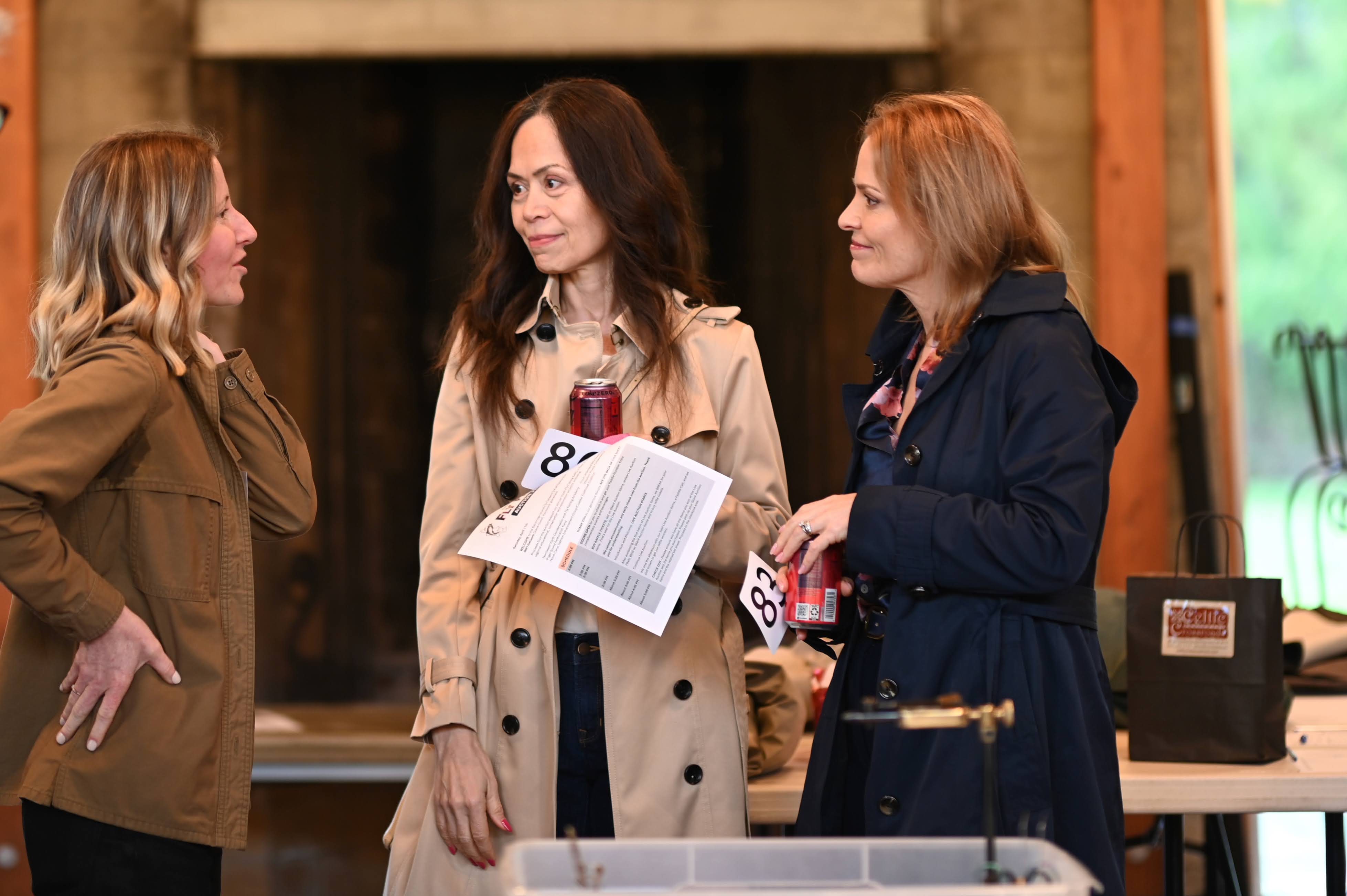 Three members in conversation at a gathering