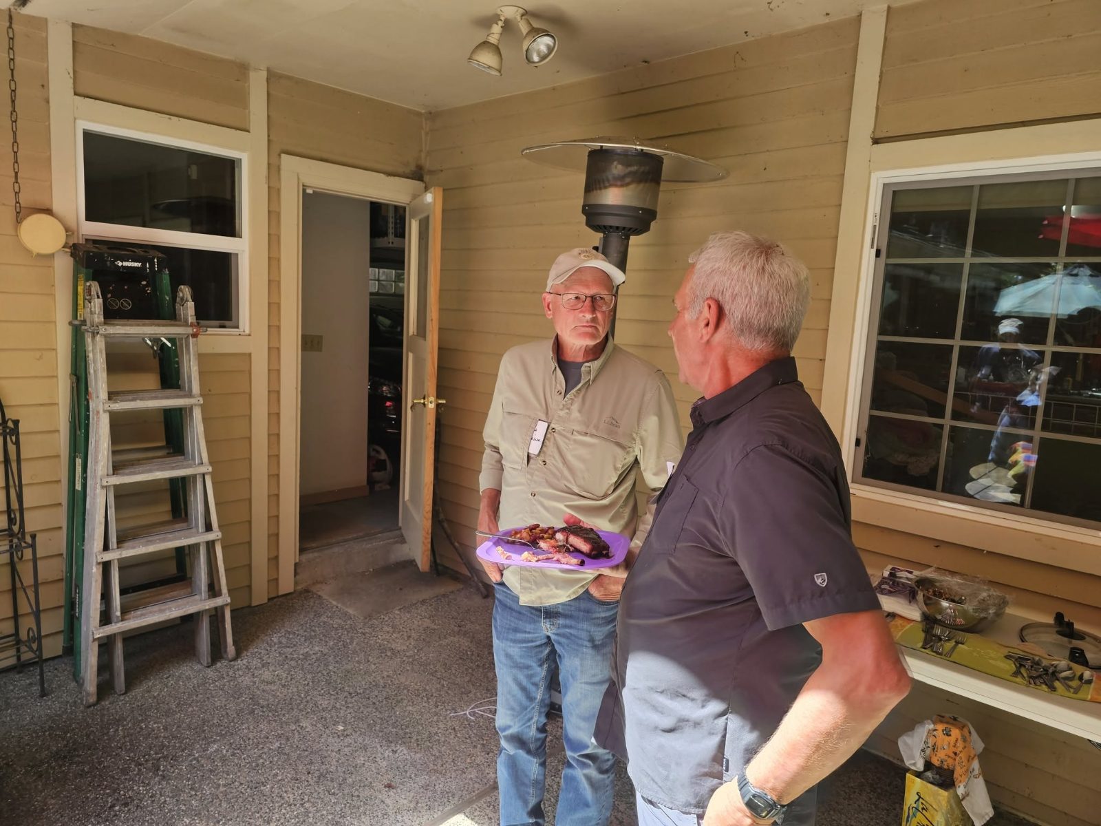 Two club members talking over plates at a club gathering